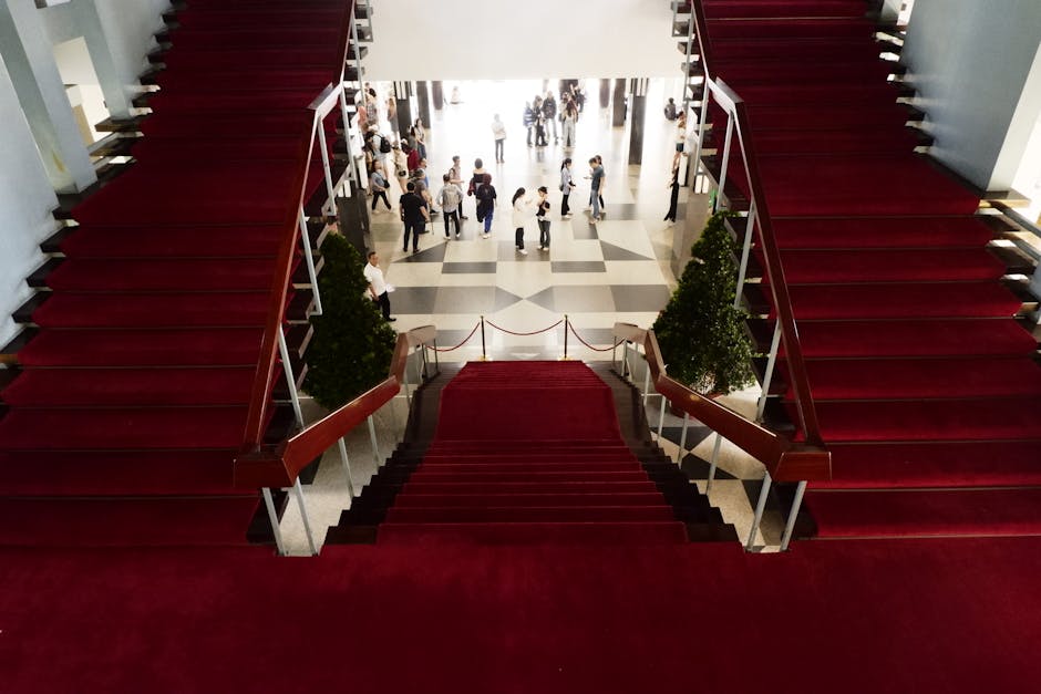 Elegant red-carpeted staircase inside a historic Vietnamese building