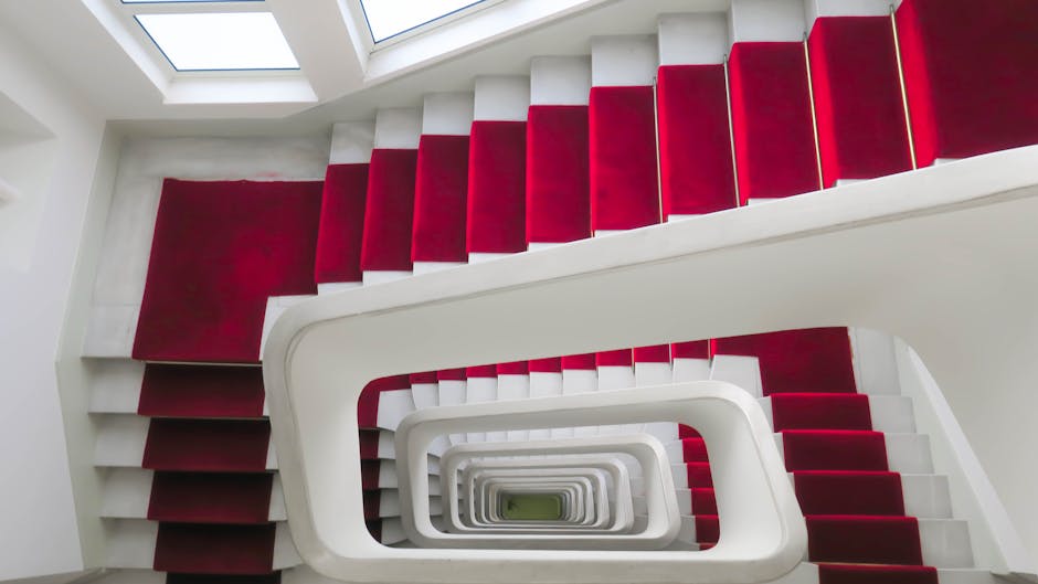 Elegant spiral staircase with vibrant red carpet